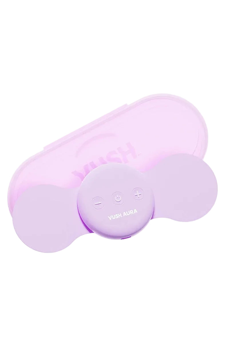 VUSH Aura lilac TENS device with two wing pads and a round control puck, beside its travel case.