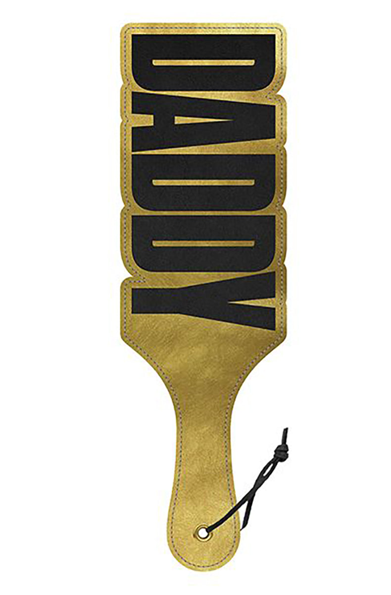 Gold faux leather paddle with DADDY in bold black cutout lettering forming the upper paddle shape, with a black wrist cord.