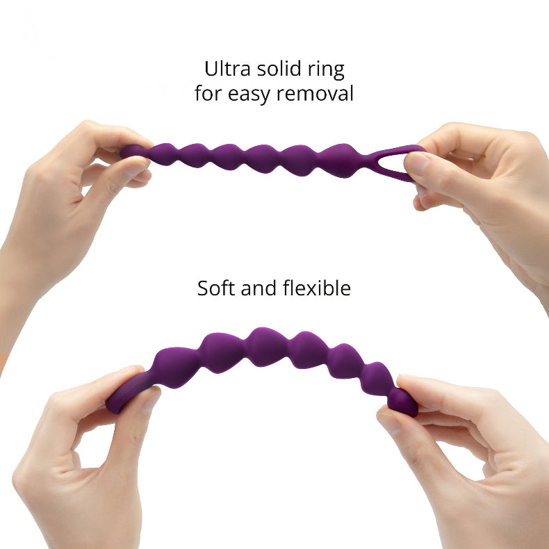 Two hands stretching the violet silicone anal bead chain straight, then bending it into an arc to show flexibility.