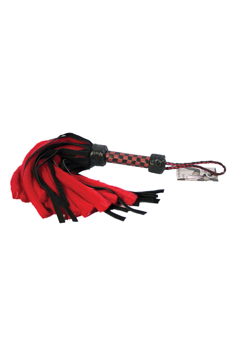 Red and black flogger with alternating red faux-fur tails and black suede tails on a red and black checkered handle.