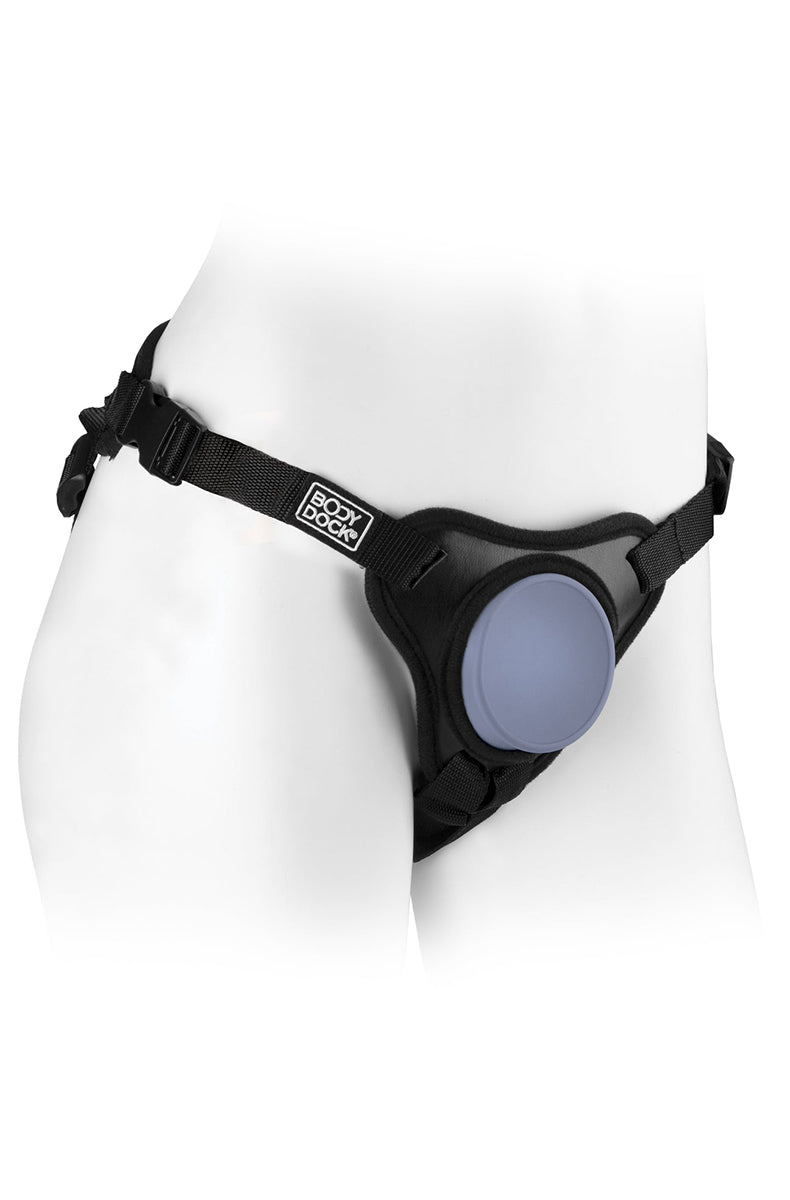 Black Body Dock SE strap-on harness on a mannequin with purple silicone suction dock plate and adjustable nylon straps.