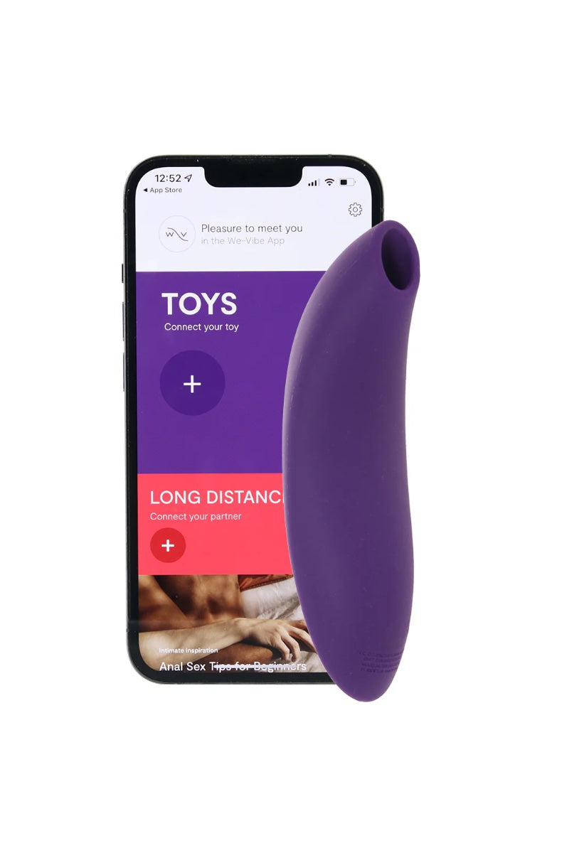 Purple vibrator next to smartphone displaying We-Vibe app interface with connection options