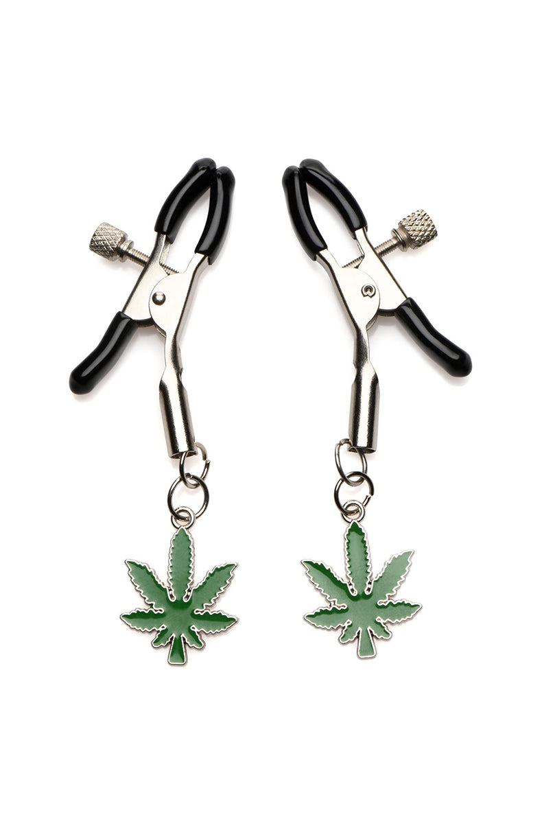 Silver tweezer-style nipple clamps with black vinyl tips and green enameled cannabis-leaf charms dangling from each clamp.