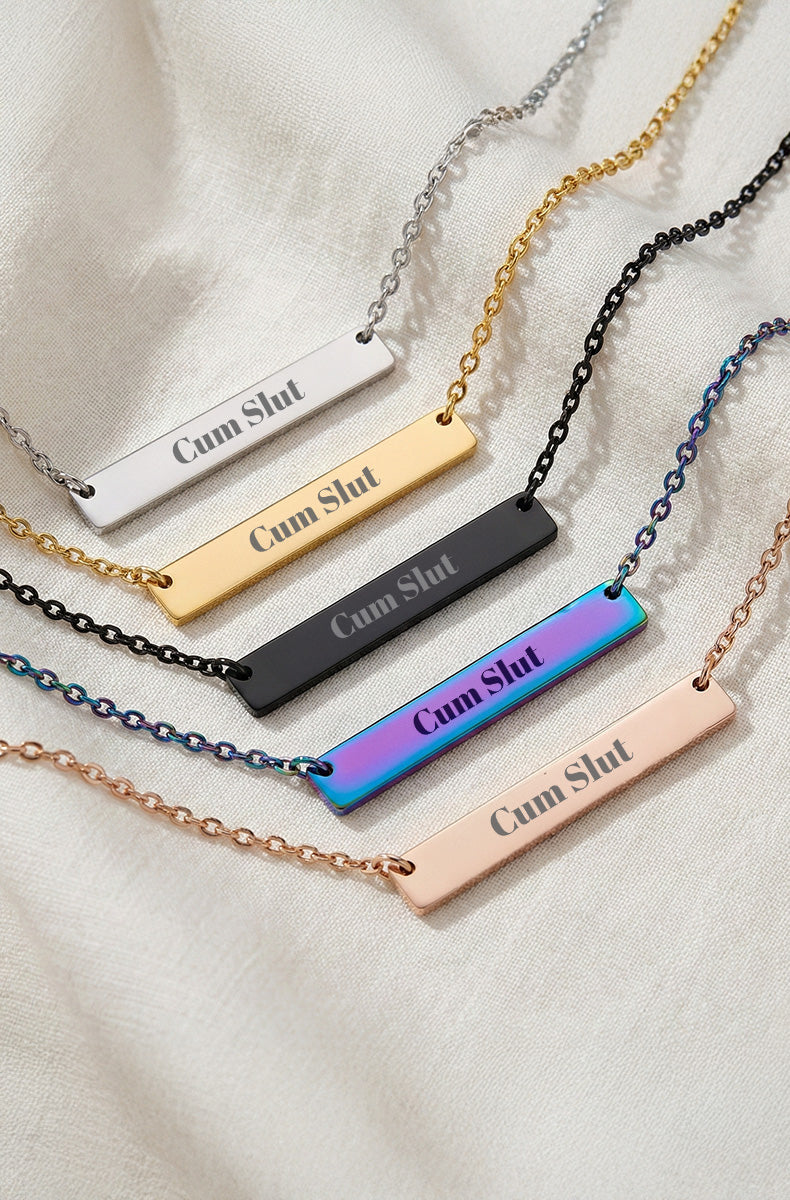 Five horizontal bar necklaces on white background showing "Cum Slut" engraving in silver, gold, black, rainbow, and rose gold finishes