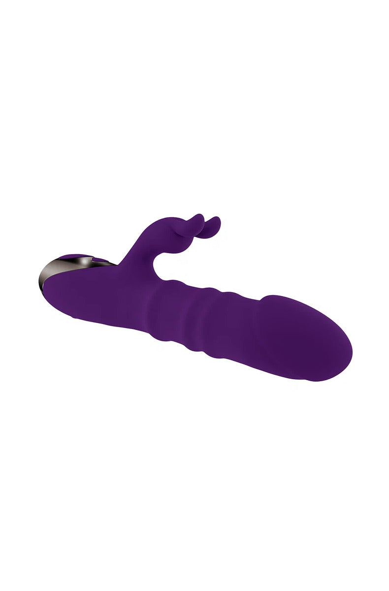 Playboy Hop To It rabbit vibrator lying down, showing the shaft rings and bunny