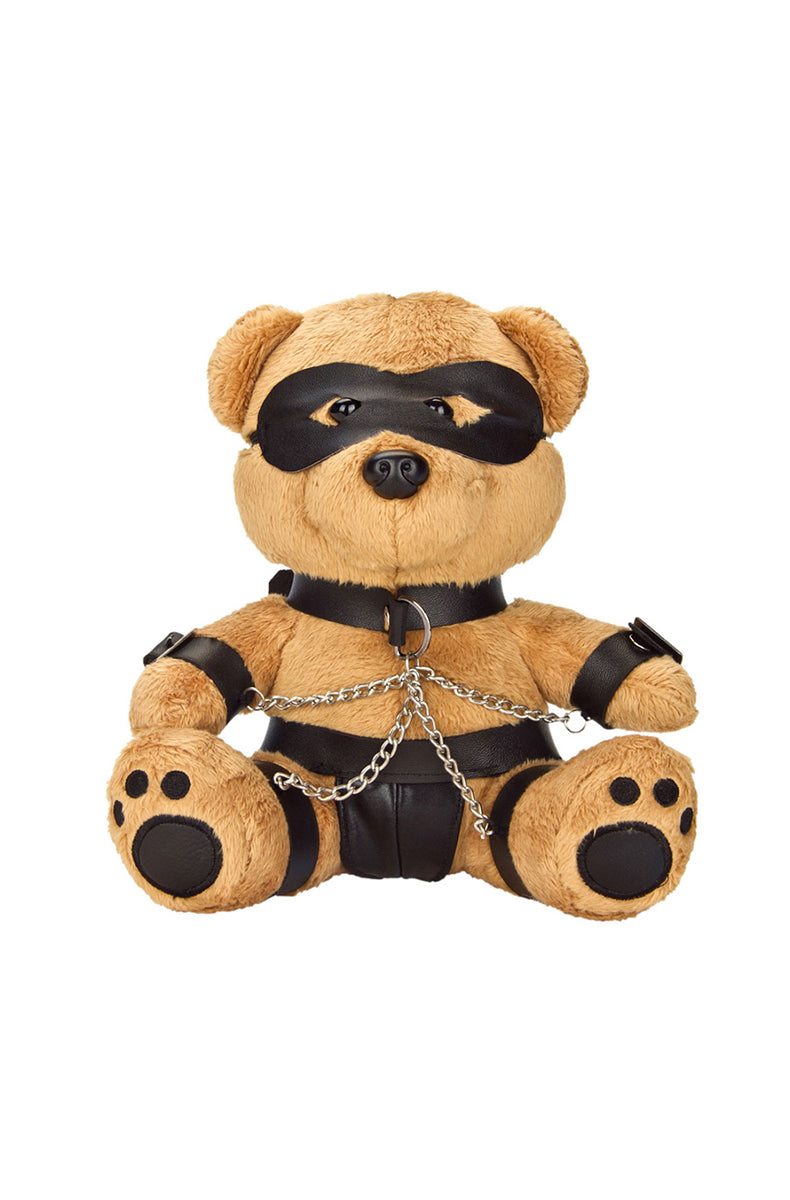 Tan plush teddy bear with black eye mask, collar, chest harness, panties, and arm and leg cuffs with silver chains.
