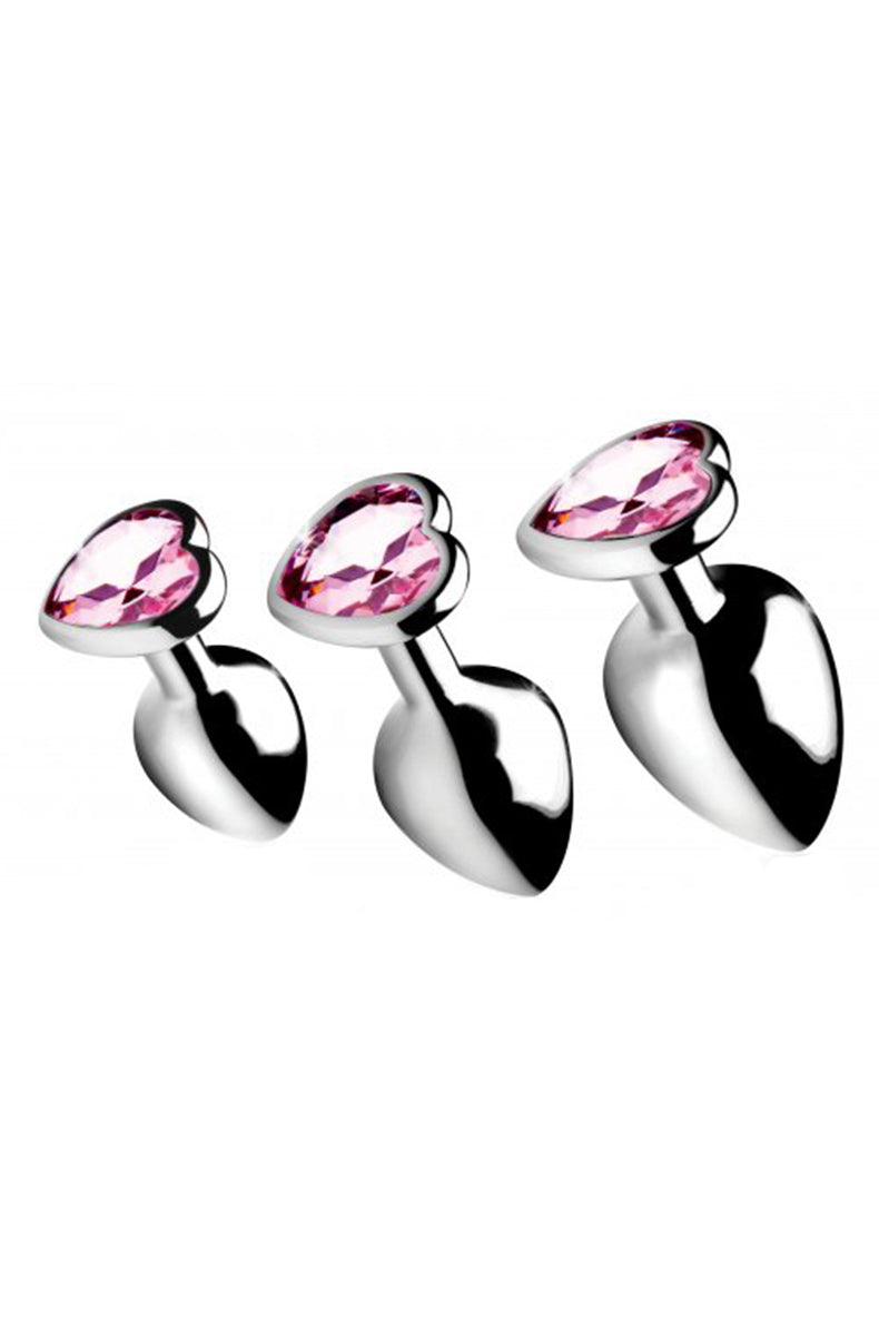 Three aluminum anal plugs with pink heart flared bases, graduated small to large. Booty Sparks Pink Heart Gem set.