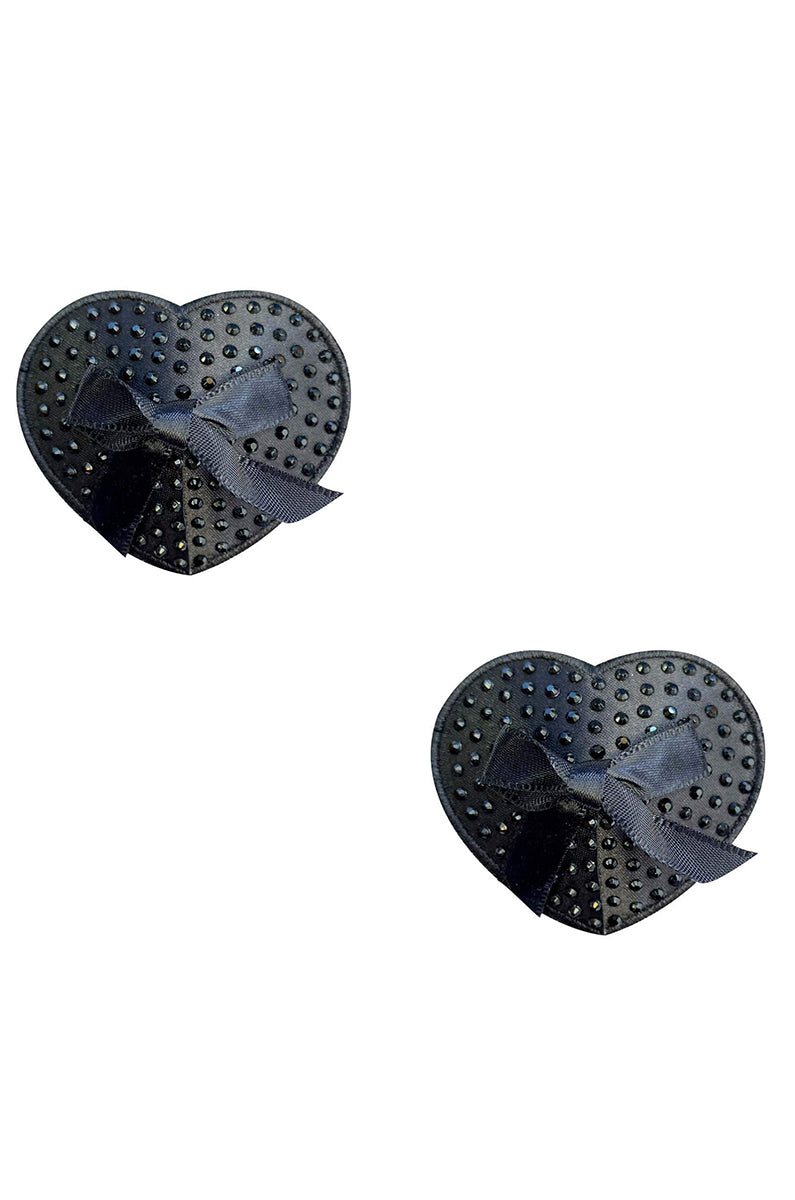 Two matte black satin heart-shaped pasties with black rhinestones scattered in a polka-dot pattern and a small black satin bow at the bottom-left of each.