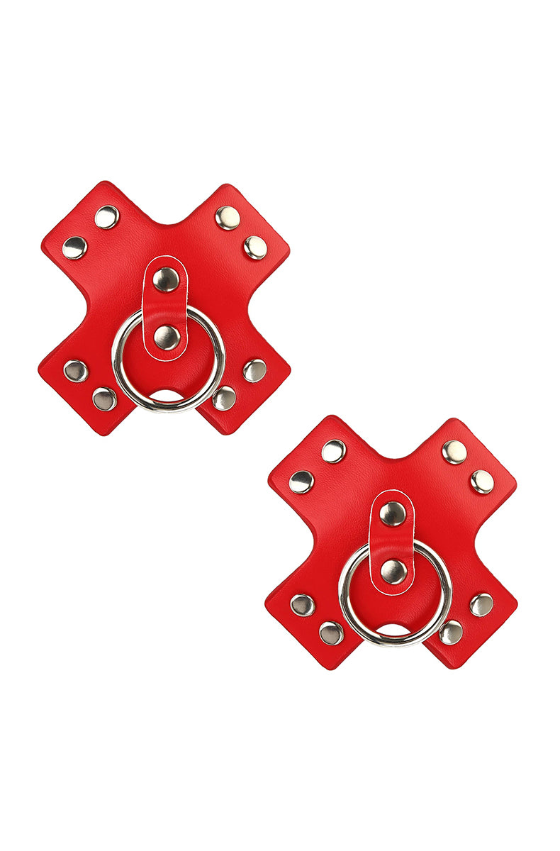 Two red X-shaped pasties with silver-tone metal rivets along each arm and a silver-tone hoop ring at the center.