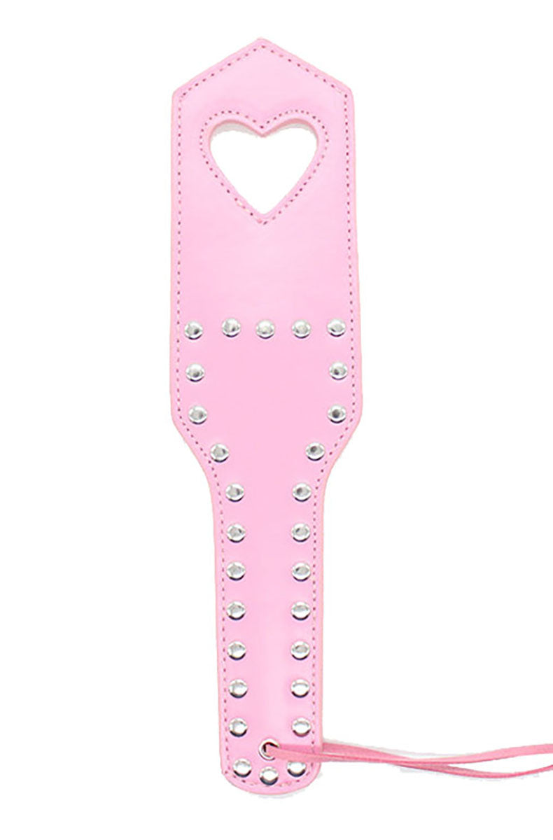 Pink vegan leather paddle with a heart-shaped cutout outlined in silver studs and rows of studs along the handle.