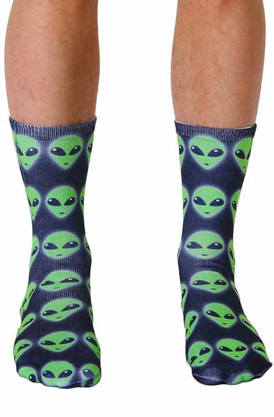 Crew socks with an all-over green alien-head photo print on a dark navy ground.