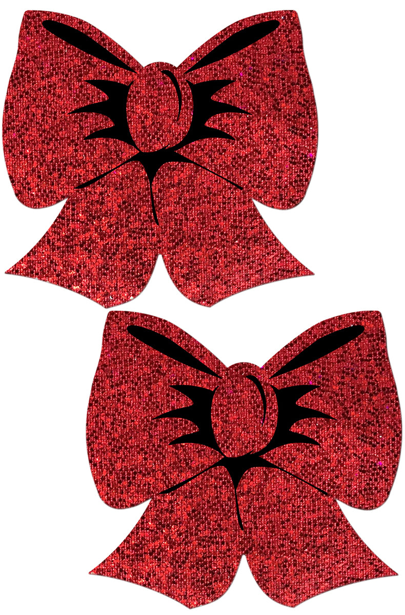 Two pasties shaped like wrapped gift bows in red holographic glitter with multiple loops, tails, and a black-detailed center knot.