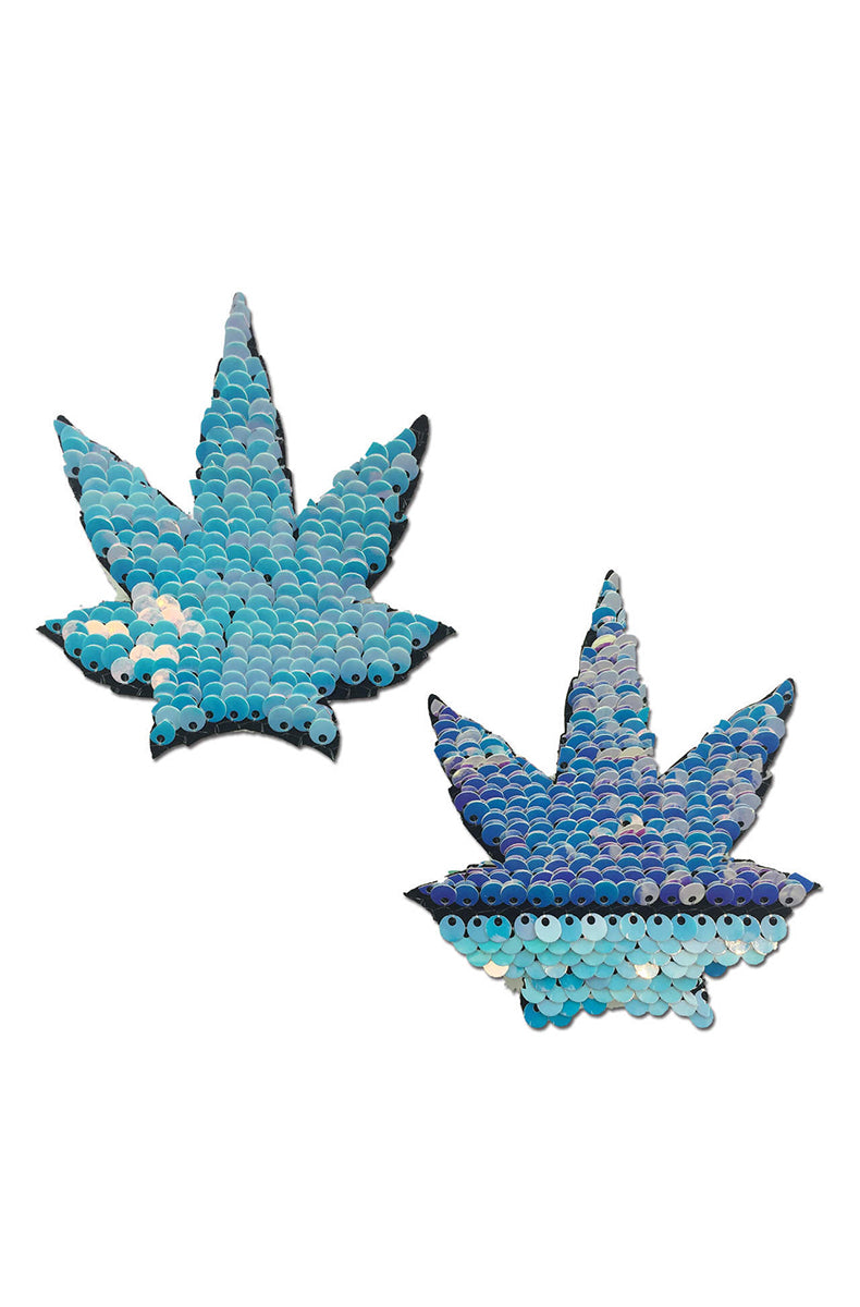 Two cannabis-leaf-shaped flip-sequin pasties: iridescent baby blue on one side, royal blue with pink-lavender shifts on the reverse.