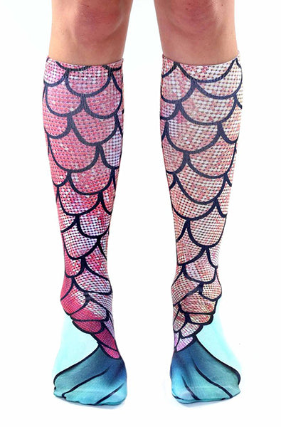 Knee-high socks with a pink and coral mermaid-scale photo print and teal-green fin tips at the cuff.