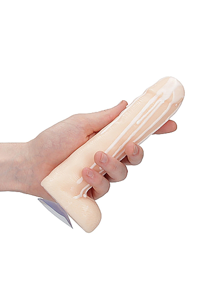 Side view of vanilla Dick Soap with Balls showing sculpted shaft, vein detail, and white-soap drip on a white background.