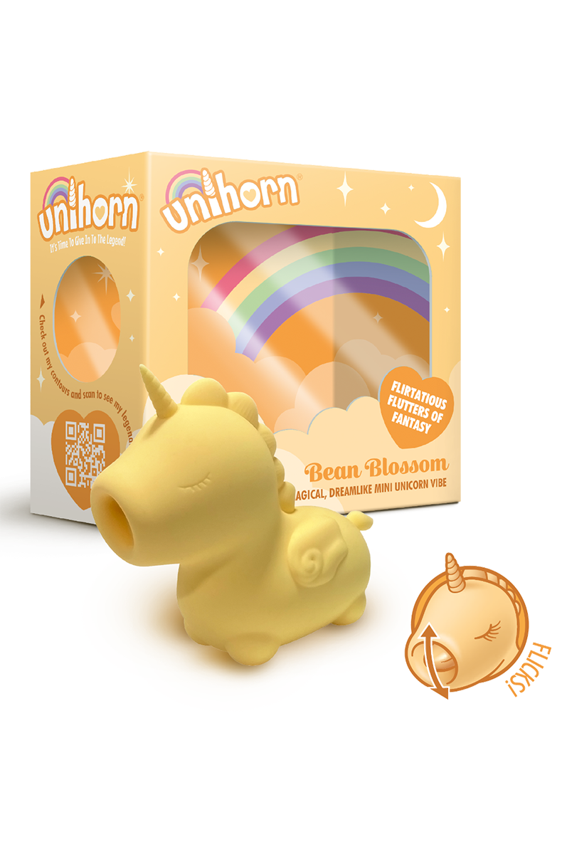 Yellow silicone Unihorn Bean Blossom unicorn vibrator with a closed mouth, next to its yellow rainbow gift box.