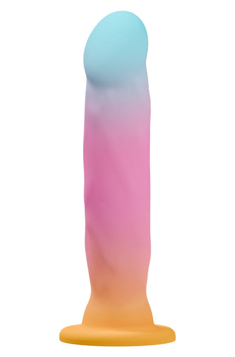 Aqua, pink and gold ombre silicone dildo with soft ridges standing on its suction cup base