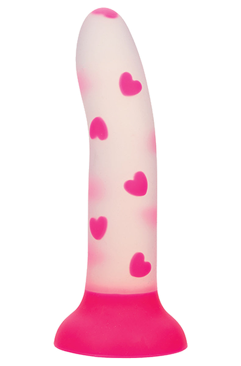 Pink heart glow in the dark dildo standing on its hot pink suction cup base