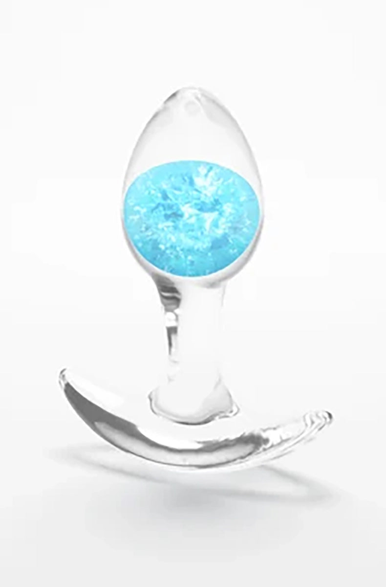 Clear silicone butt plug with a swirled blue glass marble inside the bulb, standing on its wide flat base