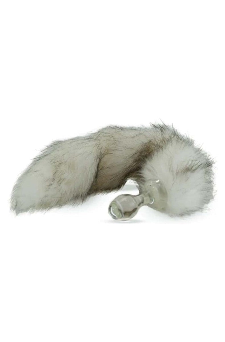 Clear glass butt plug with a long grey and white husky faux fur tail