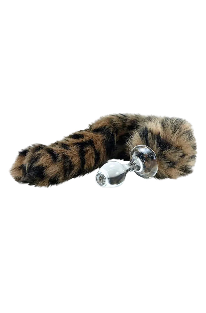 Clear glass butt plug with a long leopard print faux fur tail in tan, cream and black