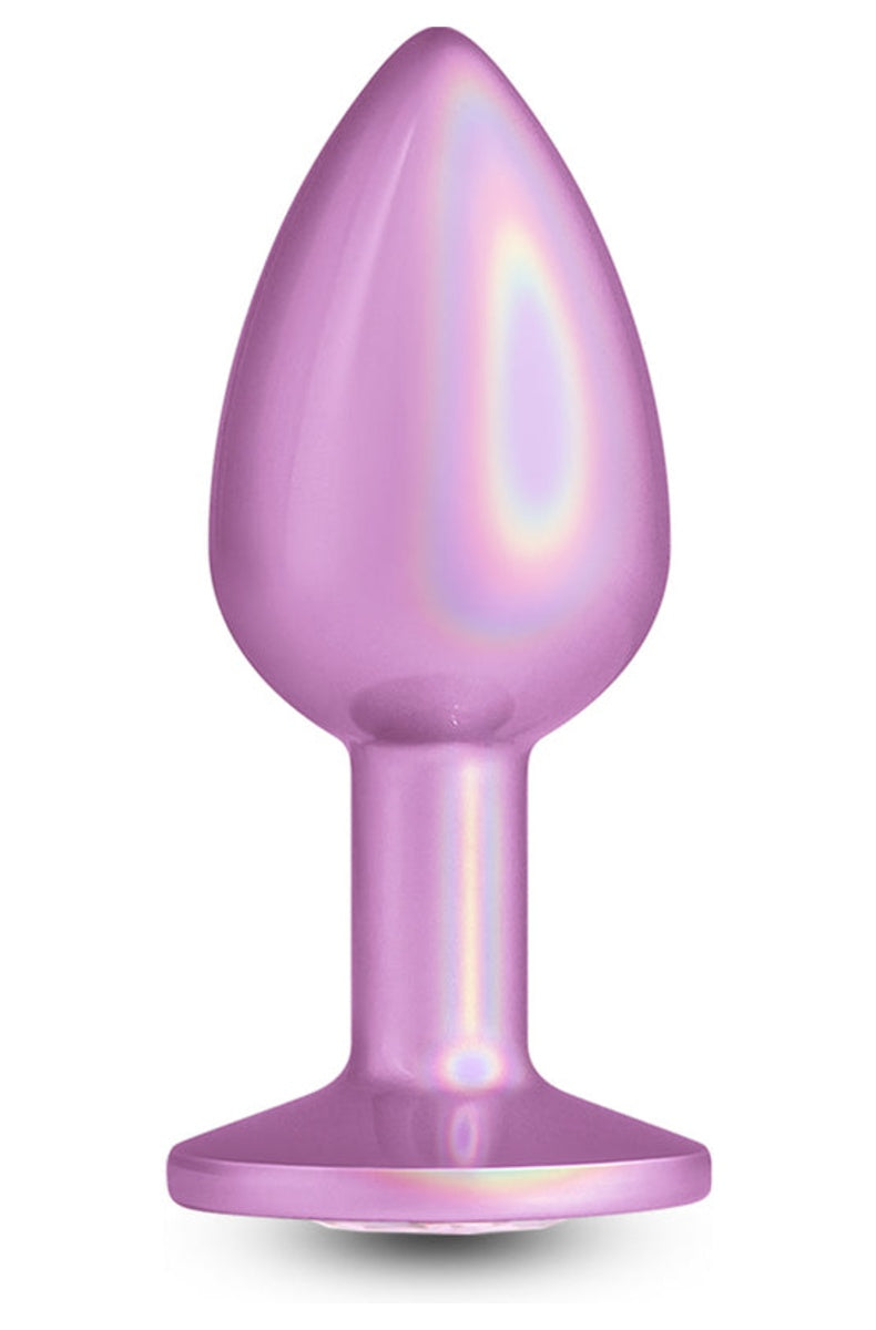 Iridescent light pink metal butt plug standing upright, tapered body and wide flared base