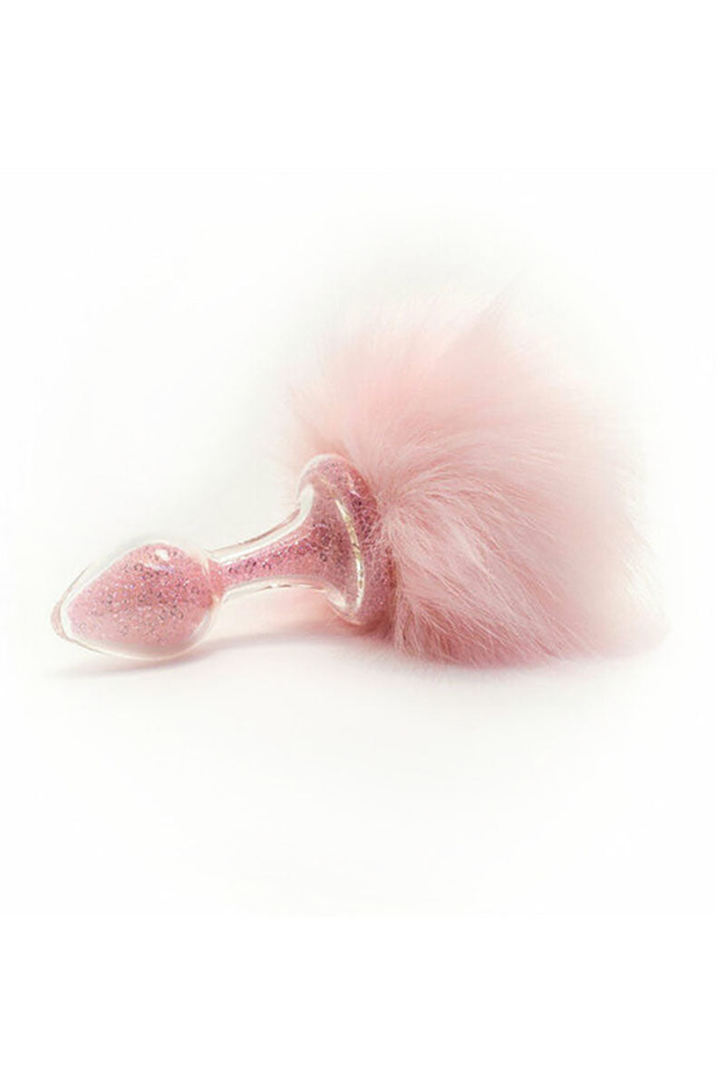 Pink glitter glass butt plug with a soft pink pom bunny tail on the base