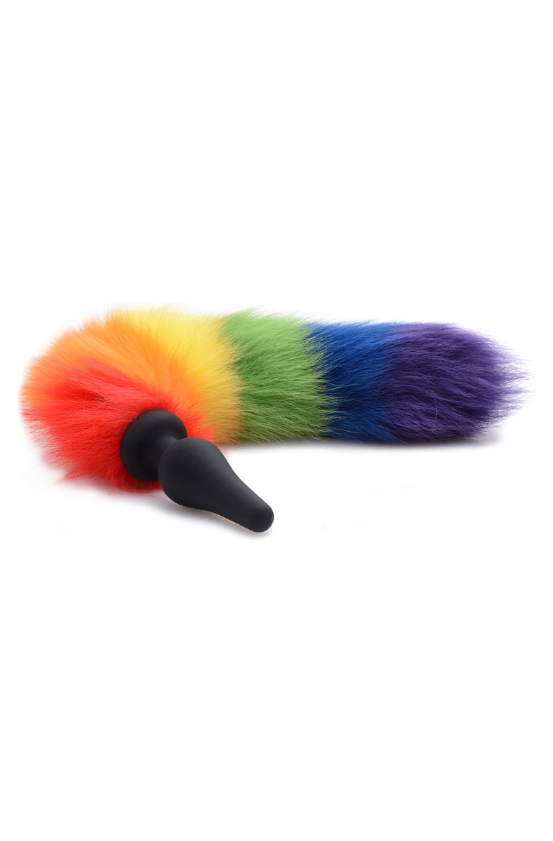 Rainbow fur tail butt plug: black silicone plug with a tapered tip and a striped red, orange, yellow, green, blue and purple faux fur tail