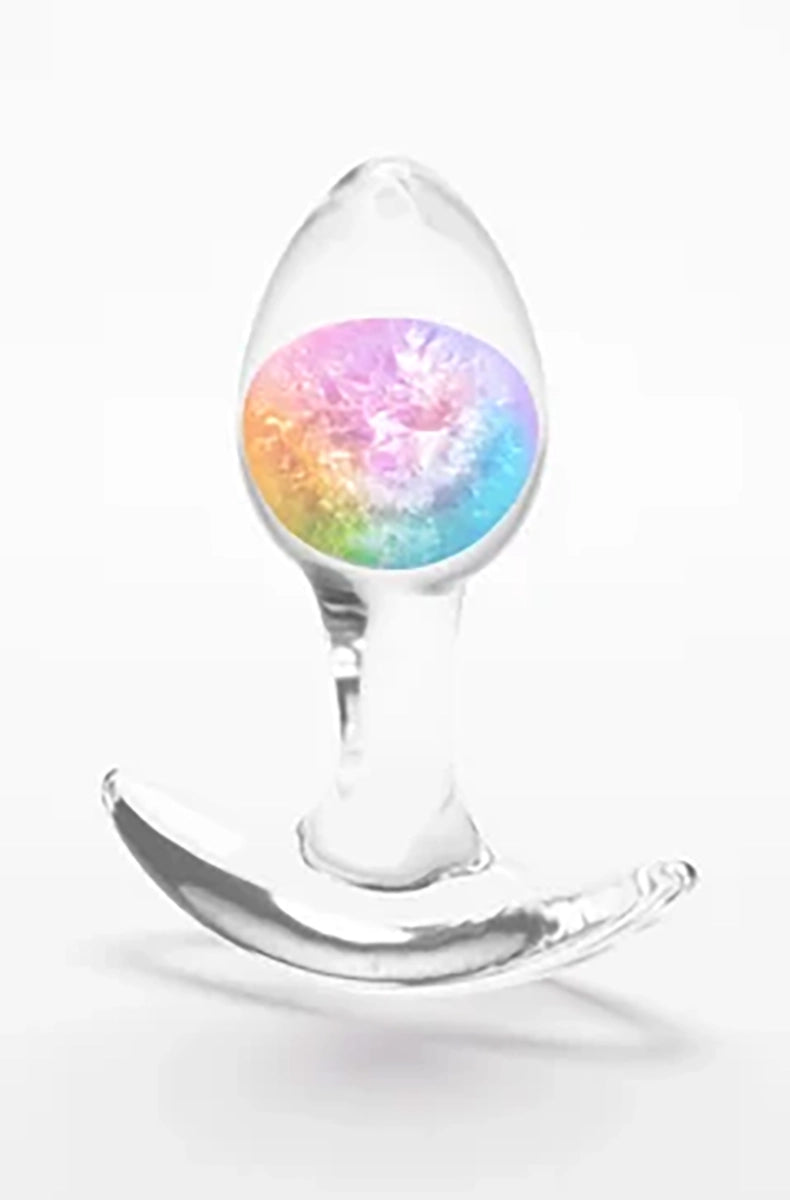 Clear silicone butt plug with a swirled rainbow glass marble inside the bulb, standing on its wide flat base