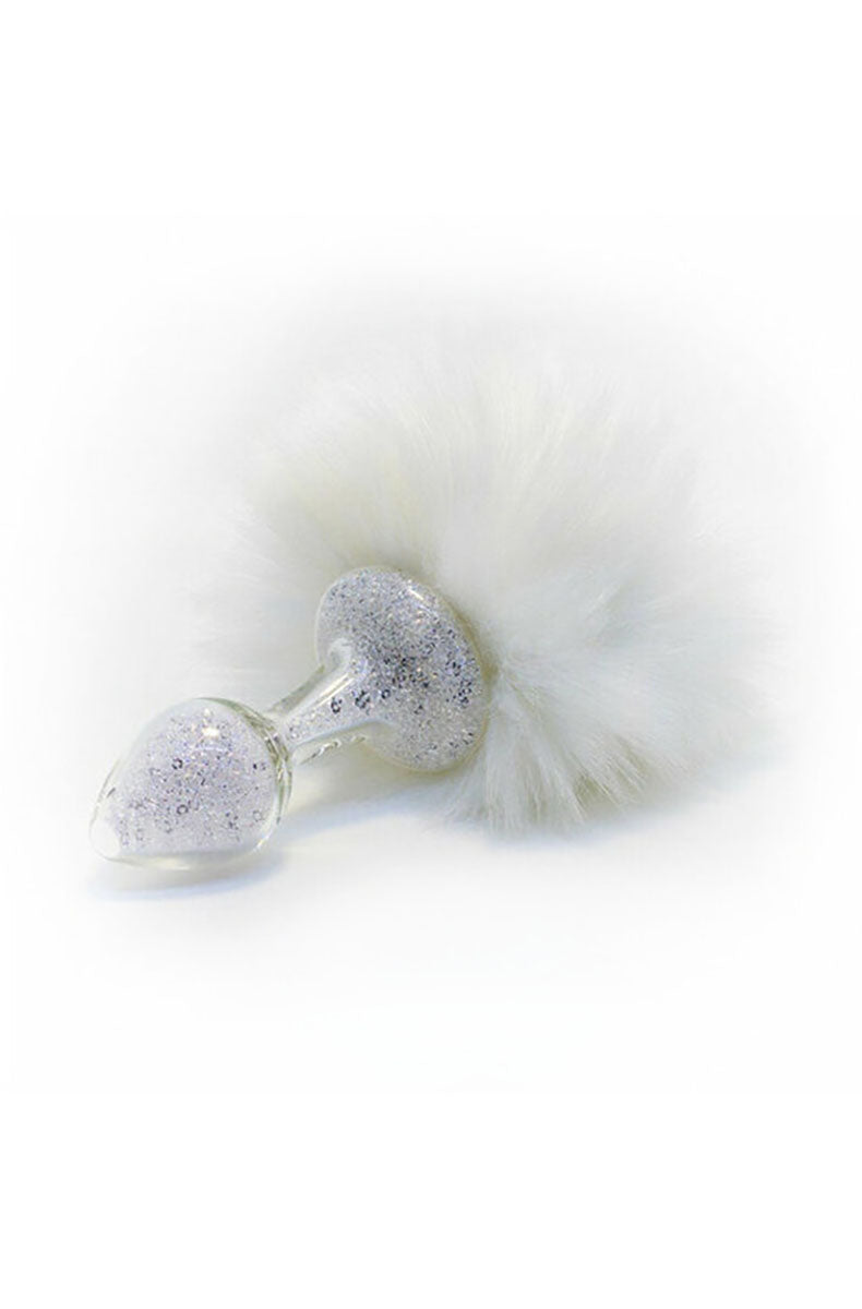 Glitter glass butt plug with a soft white pom bunny tail on the base