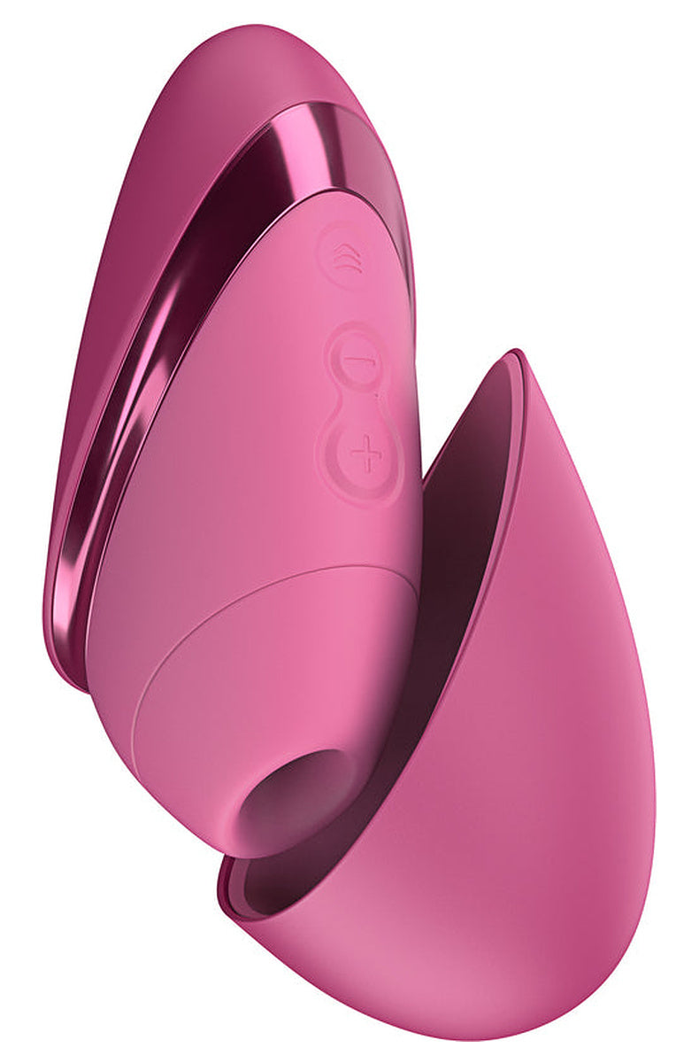Vibrant Pink Womanizer Next Liberty with its magnetic cap partly open, showing the silicone head and buttons.