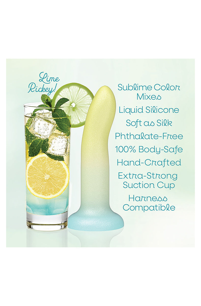 Yellow, mint and aqua ombre dildo beside a lime rickey cocktail: liquid silicone, suction cup, harness compatible