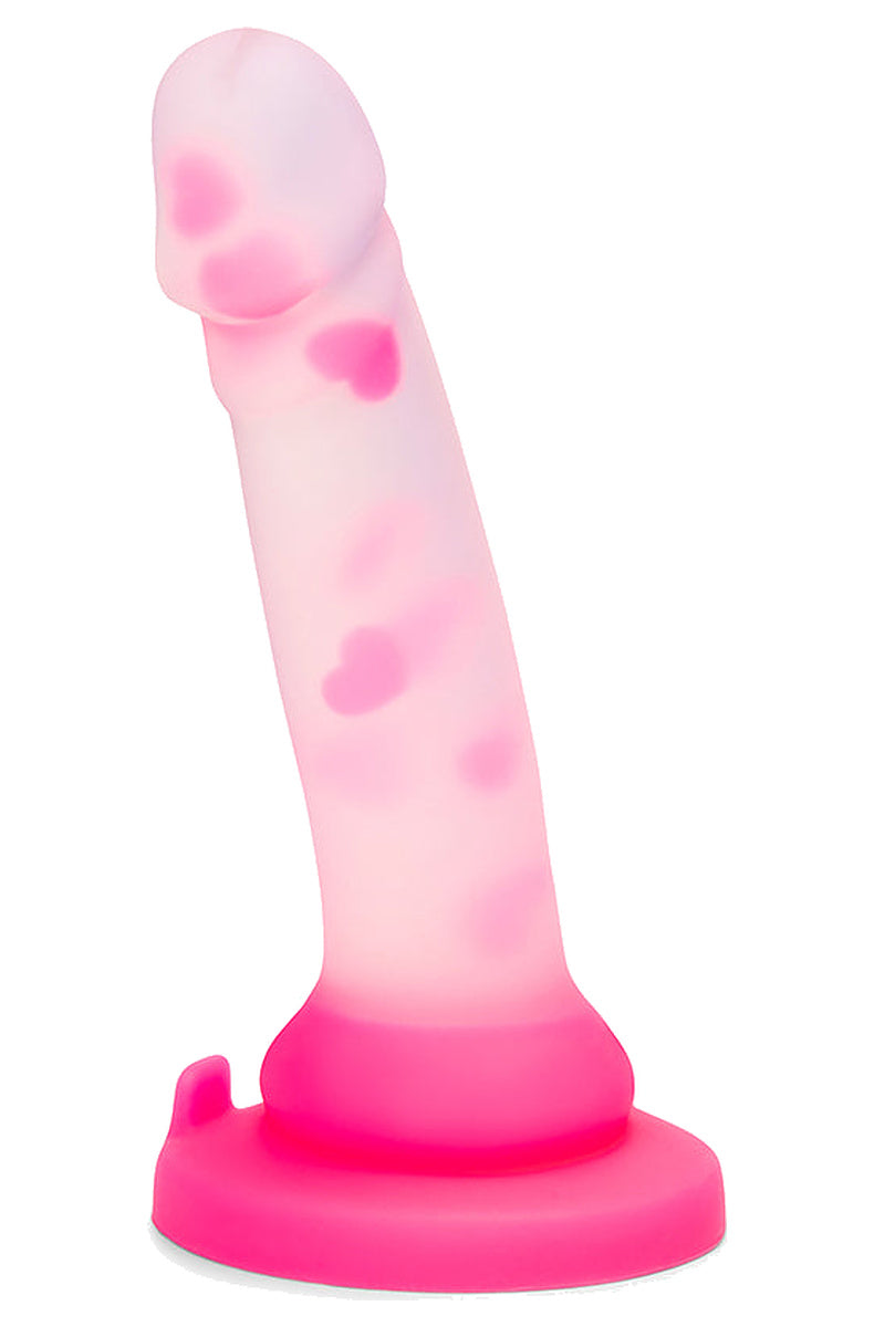 Clear silicone dildo with pink hearts, side view showing the gentle curve