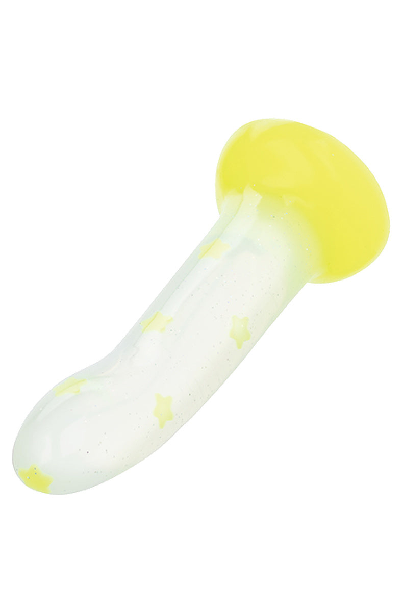 Yellow star glow in the dark dildo lying at an angle showing the neon yellow suction base