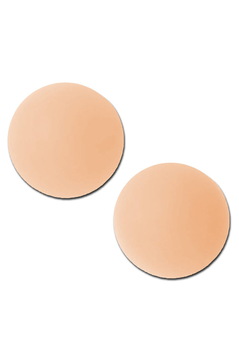 Two light tone round silicone nipple covers side by side