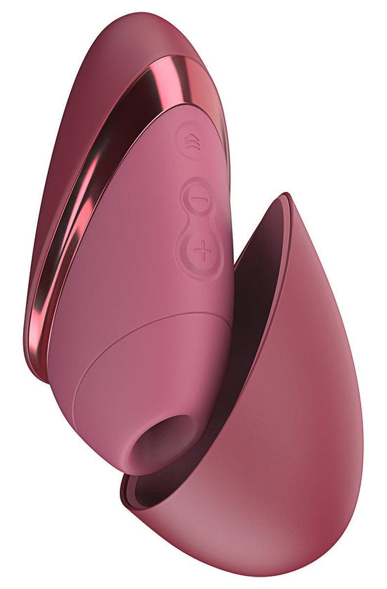 Bordeaux Womanizer Next Liberty with its magnetic cap partly open, showing the silicone head and buttons.