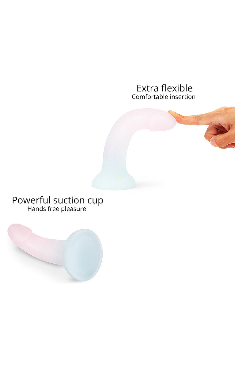 Pearl and mint glitter dildo bending under a fingertip, and its powerful suction cup base