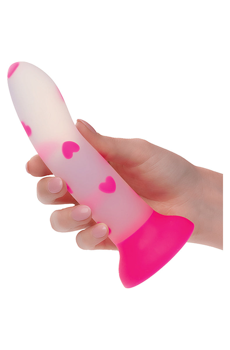 Hand holding the frosted pink heart dildo to show its size