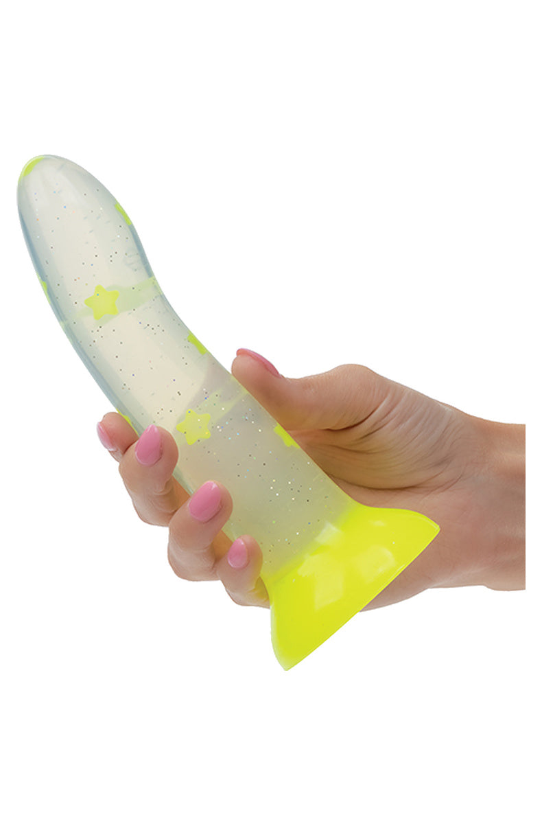 Hand holding the clear yellow star dildo to show its size