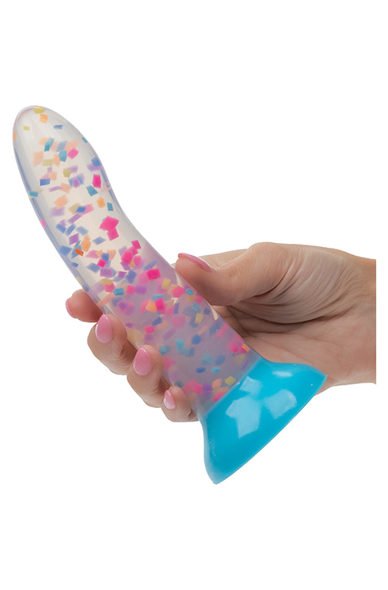 Hand holding the clear confetti dildo to show its size