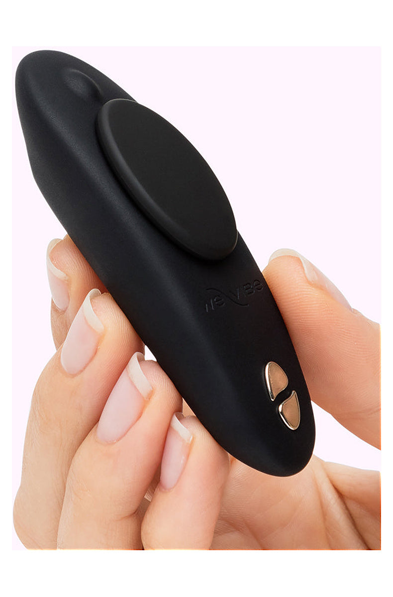 Hand holding the black We-Vibe Moxie+ wearable clitoral vibrator