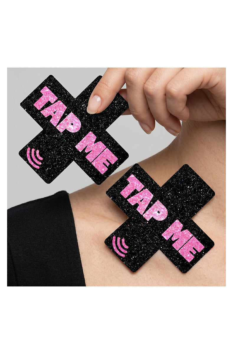 Black glitter TAP ME cross pasties shown worn on the body
