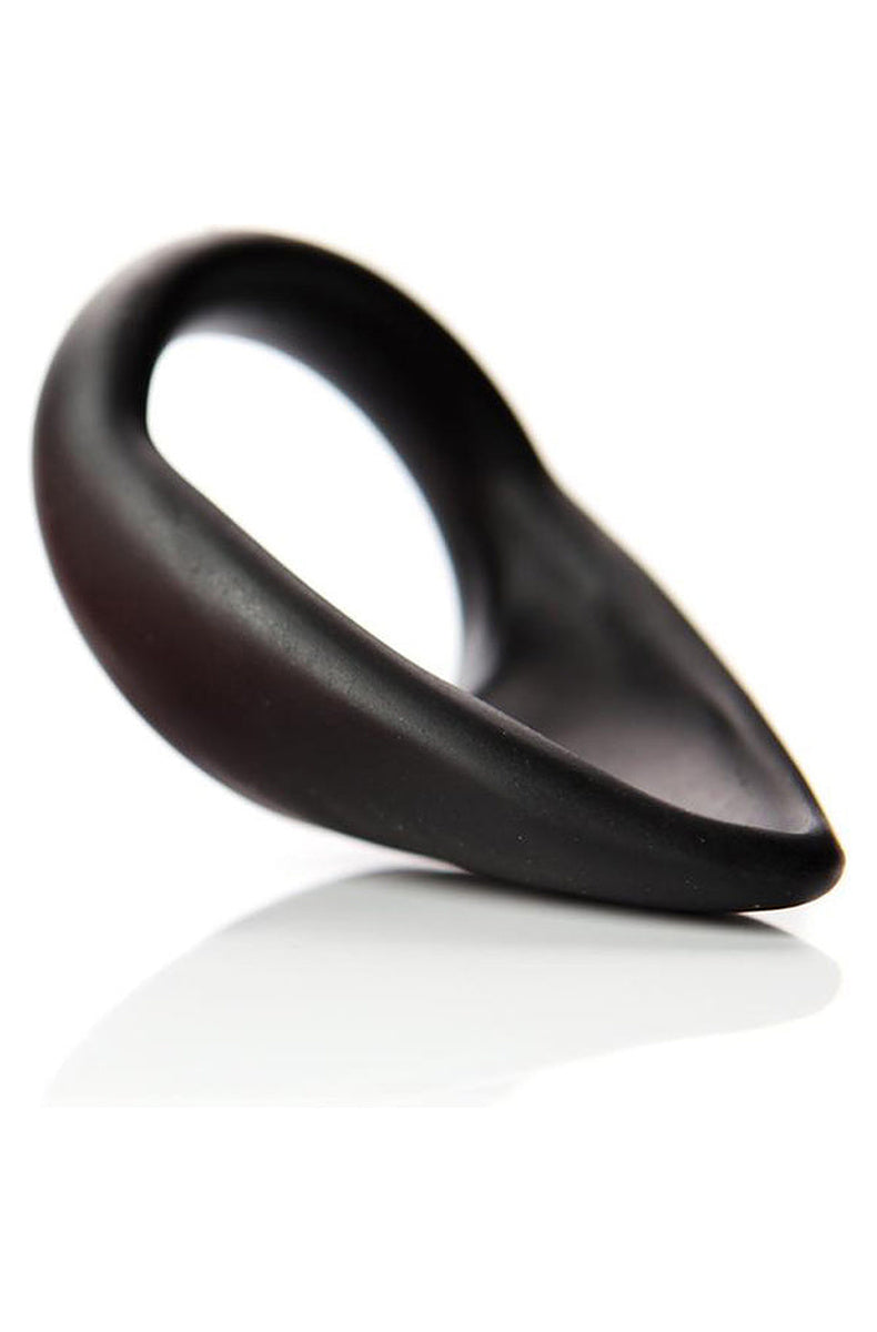 Close angled view of the Tantus C-Sling in onyx silicone, tongue tapering back from the ring