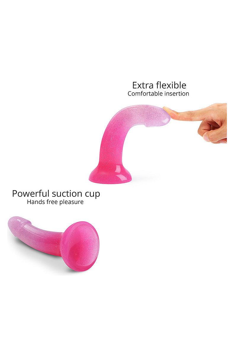 Pink glitter dildo bending under a fingertip, and its powerful suction cup base