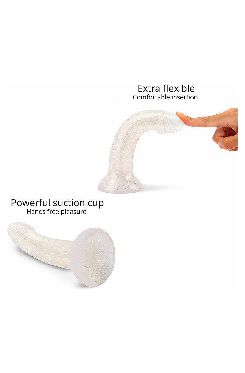 Clear gold glitter dildo bending under a fingertip, and its powerful suction cup base