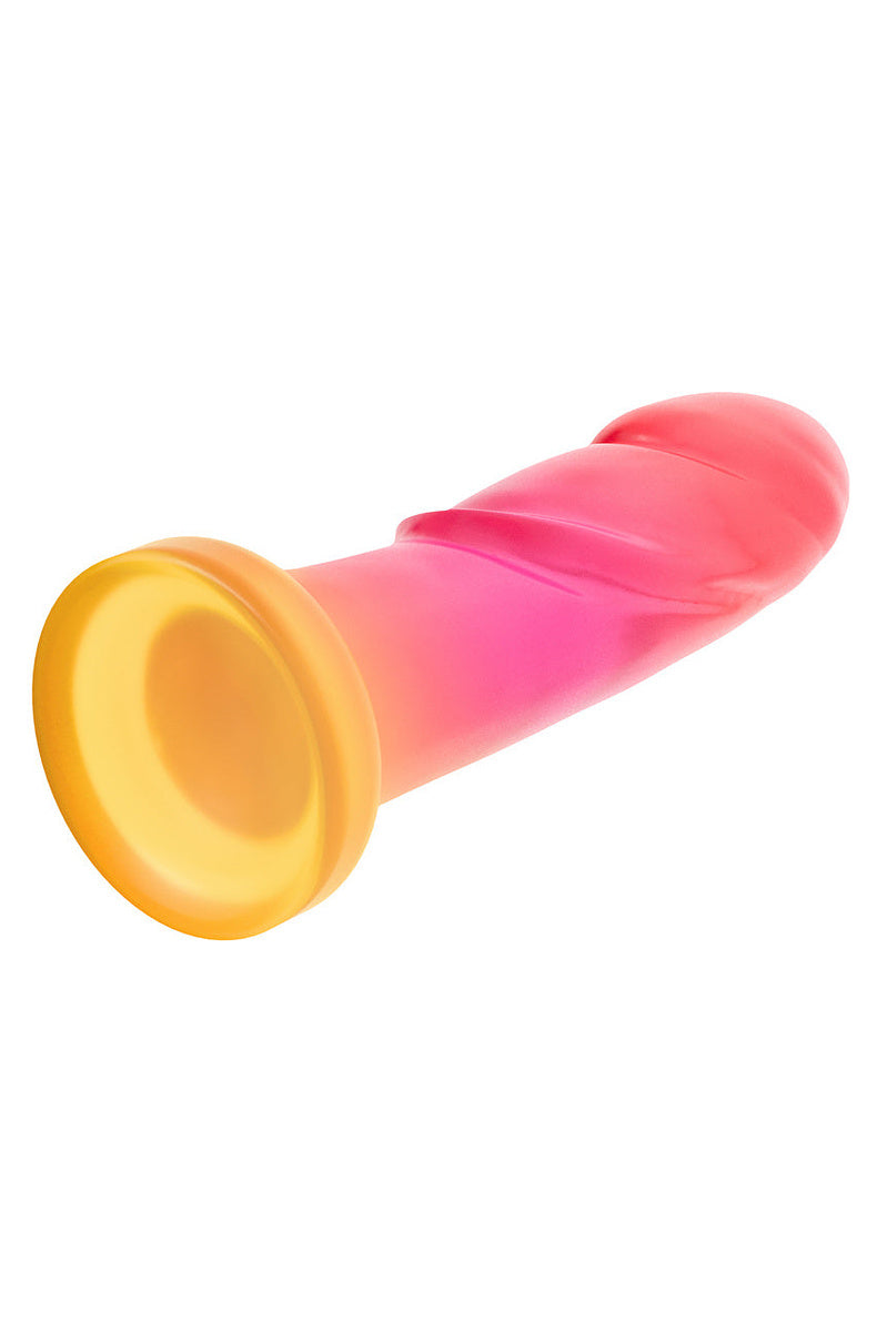 Pink and gold ombre dildo lying on its side with the gold suction base