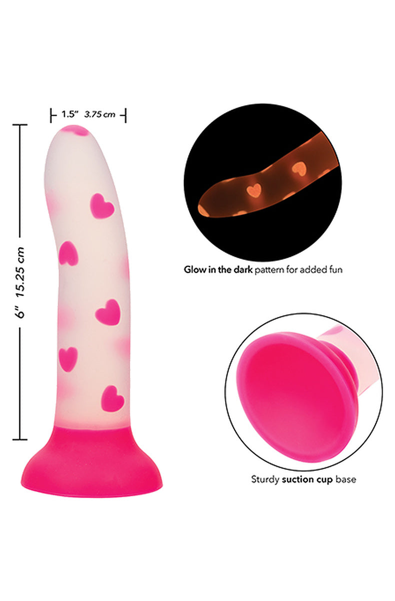 Pink heart dildo size diagram, 6 inches long and 1.5 inches wide, with the hearts glowing in the dark