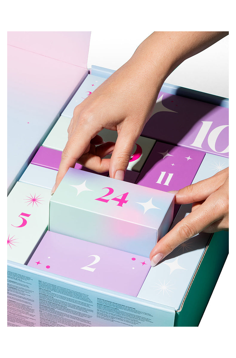 Hands lifting door 24 out of the open 24 day advent calendar