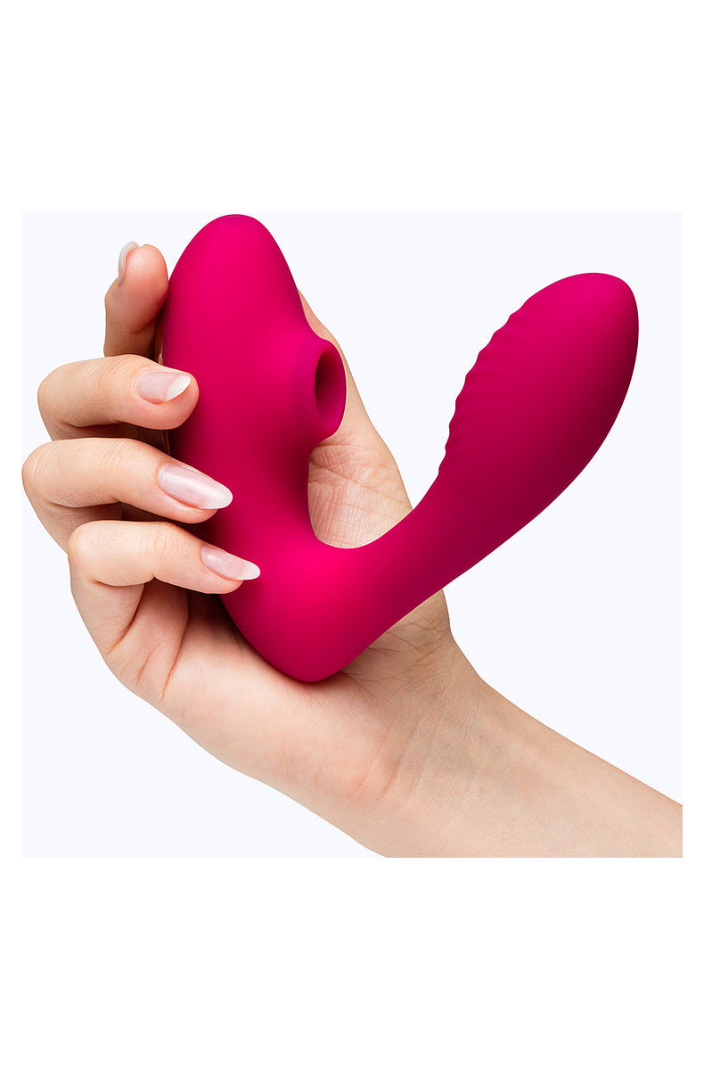Hand holding the pink G-spot and clitoral dual stimulator