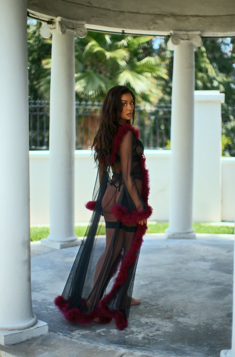 Black marabou robe falling open below the sash, floor length